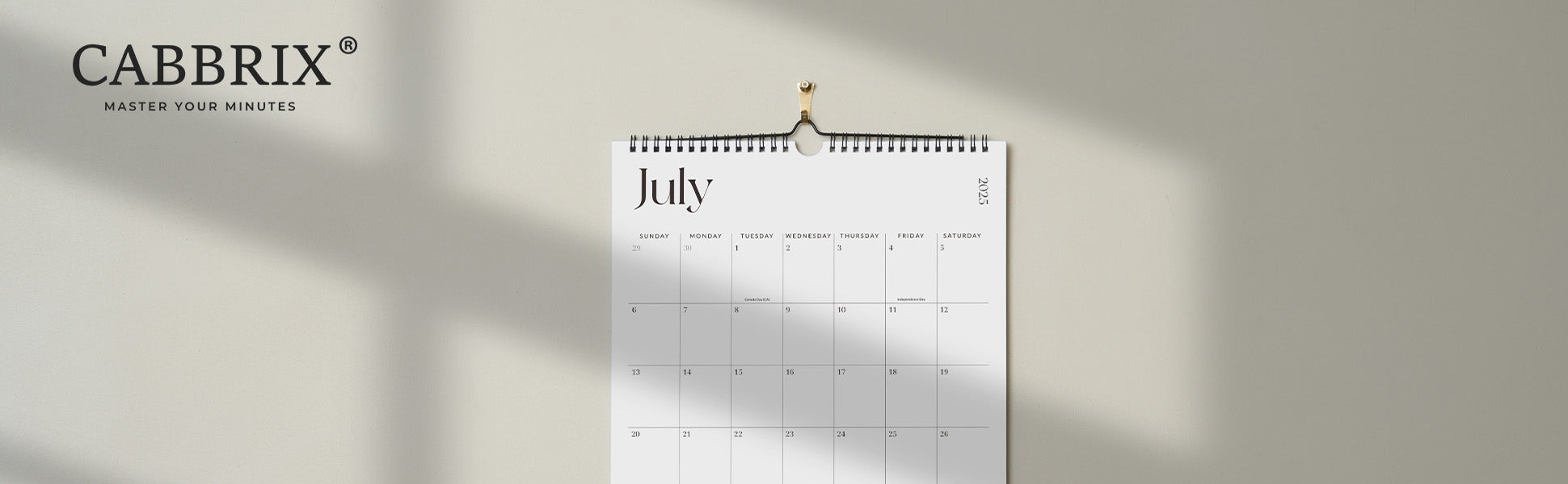 Calendar for July hanging on a wall with Cabbrix branding.