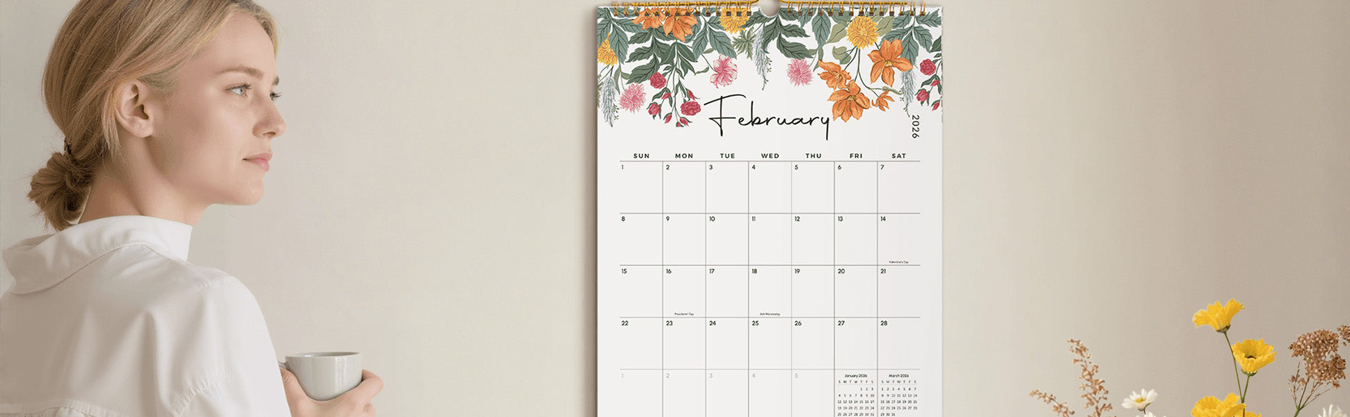 Woman holding a mug with a floral calendar on a beige wall