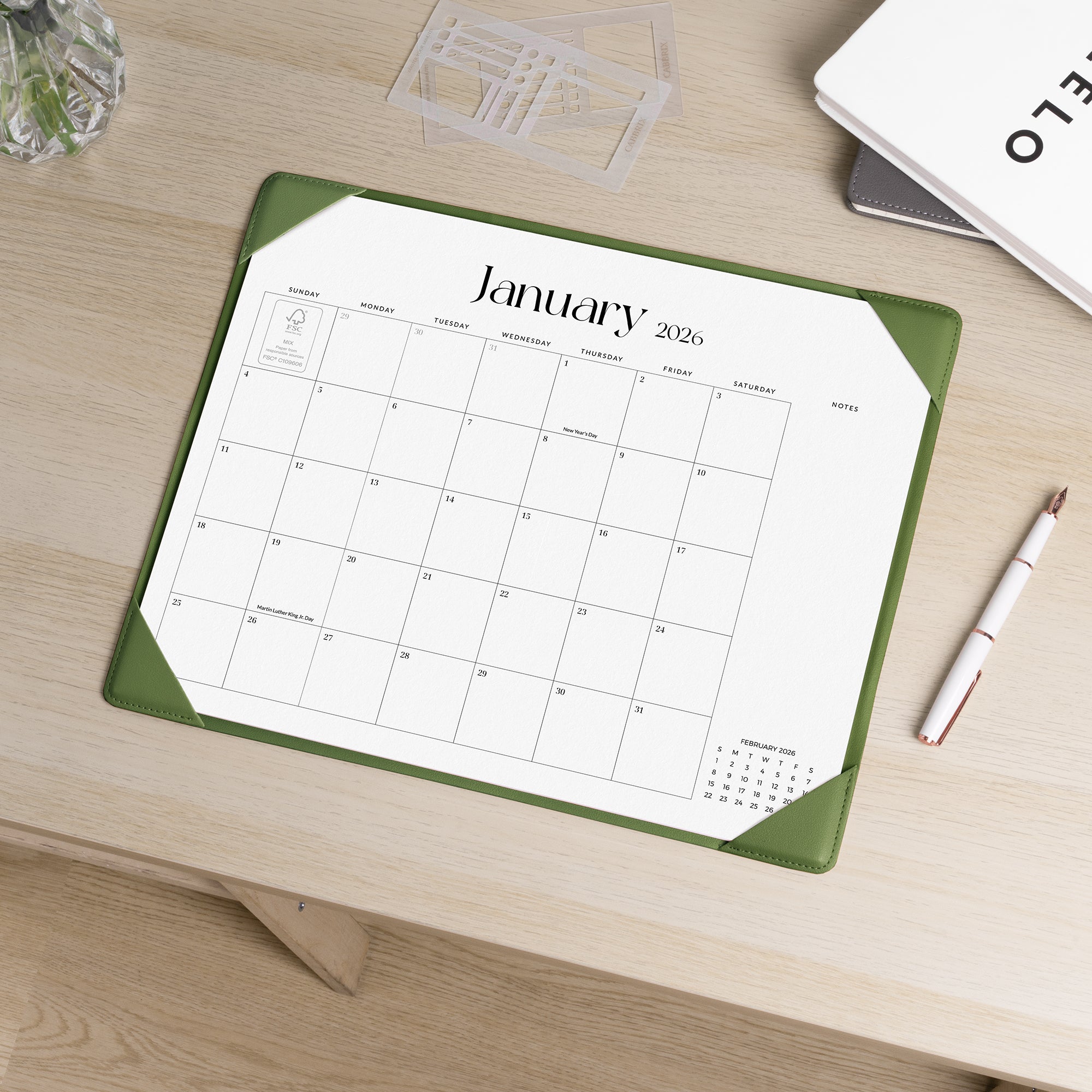 Calendar mat with January 2026 on a wooden desk