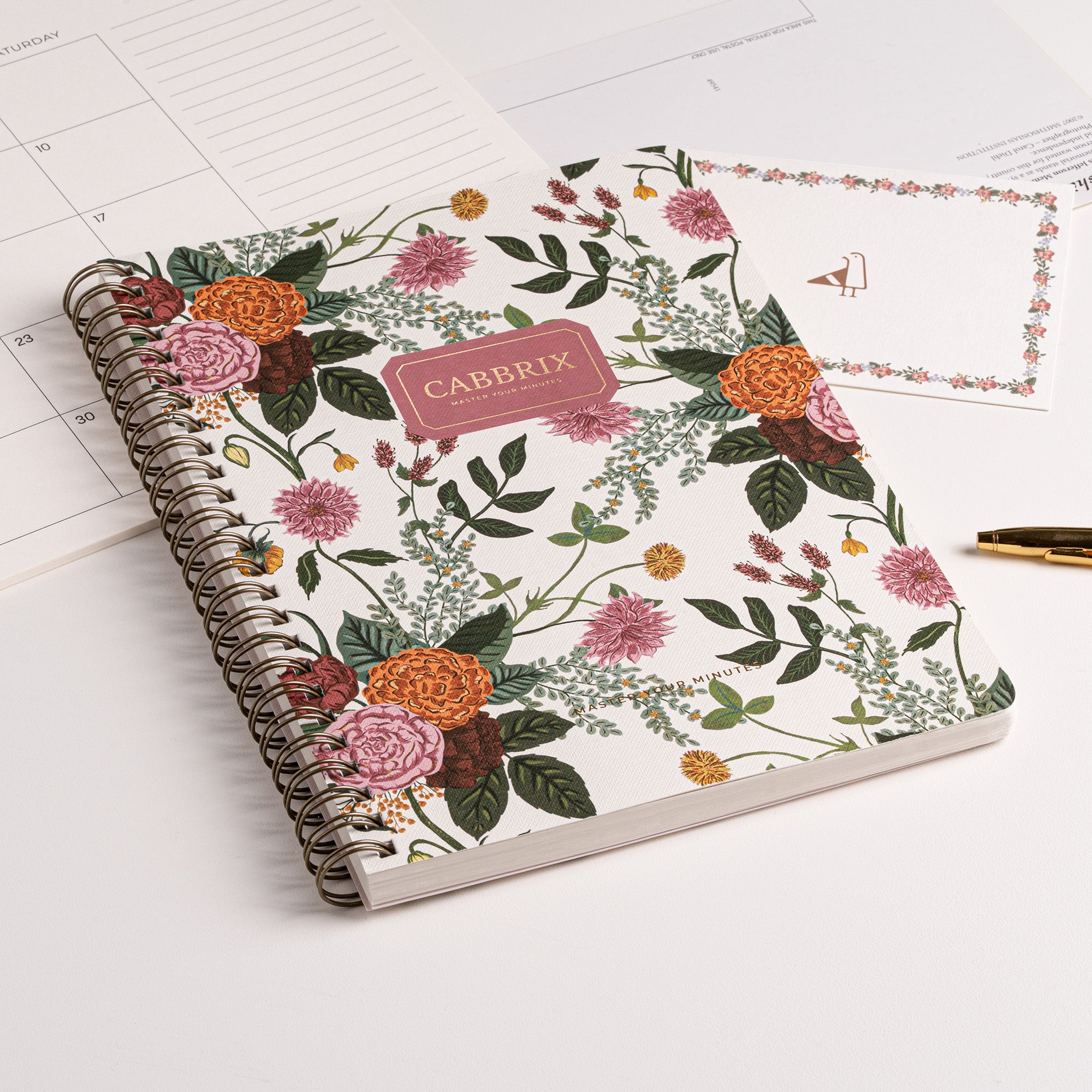 Notebook with floral design and 'CABBRIX' branding on a calendar background