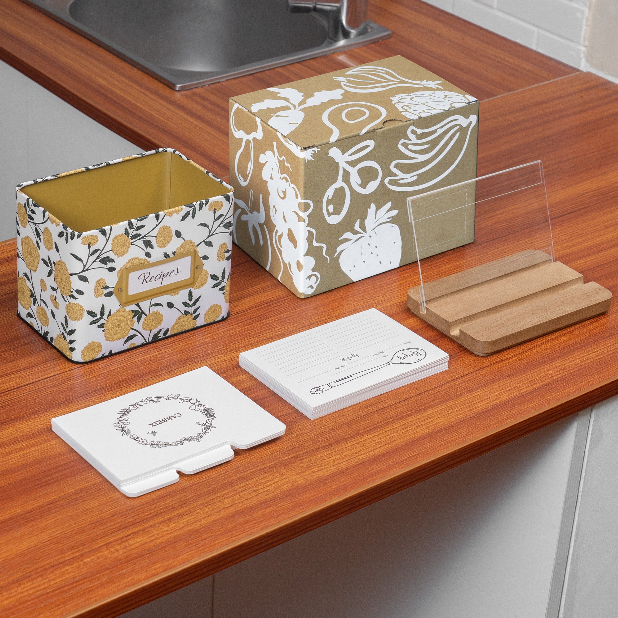 Decorative boxes and coasters on a kitchen counter with a sink in the background