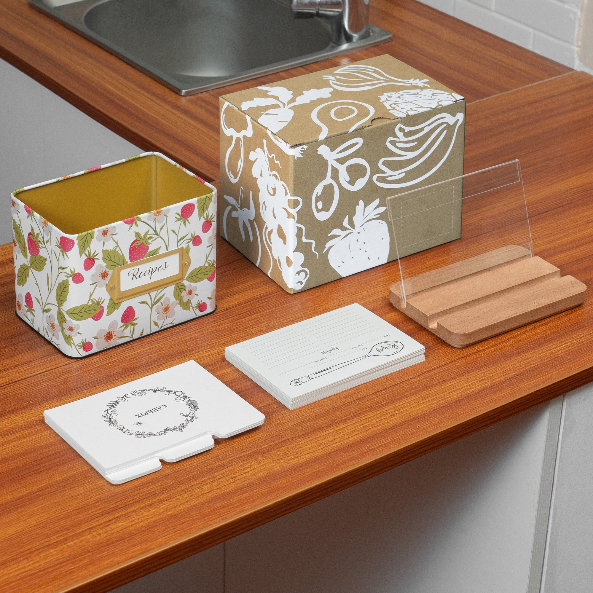 Kitchen counter with various items including a floral container, patterned box, and cutting board.