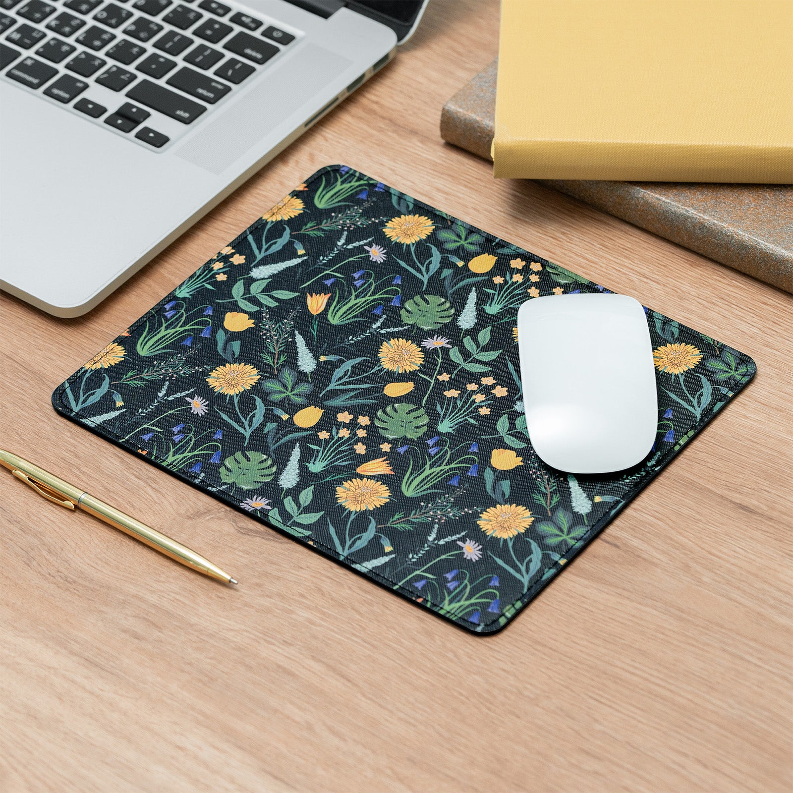 Floral patterned mouse pad on a desk with a laptop, mouse, and pen.