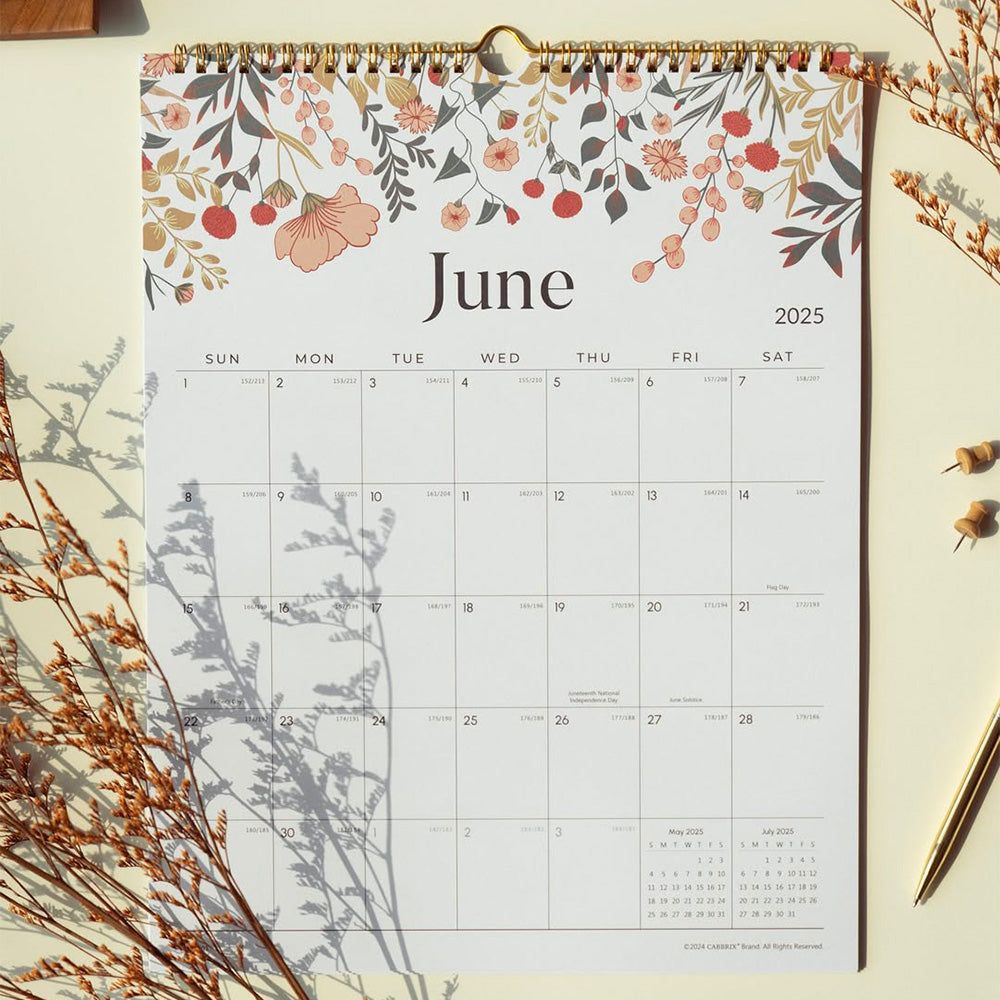 Floral calendar for June 2025 on a light surface with decorative elements.