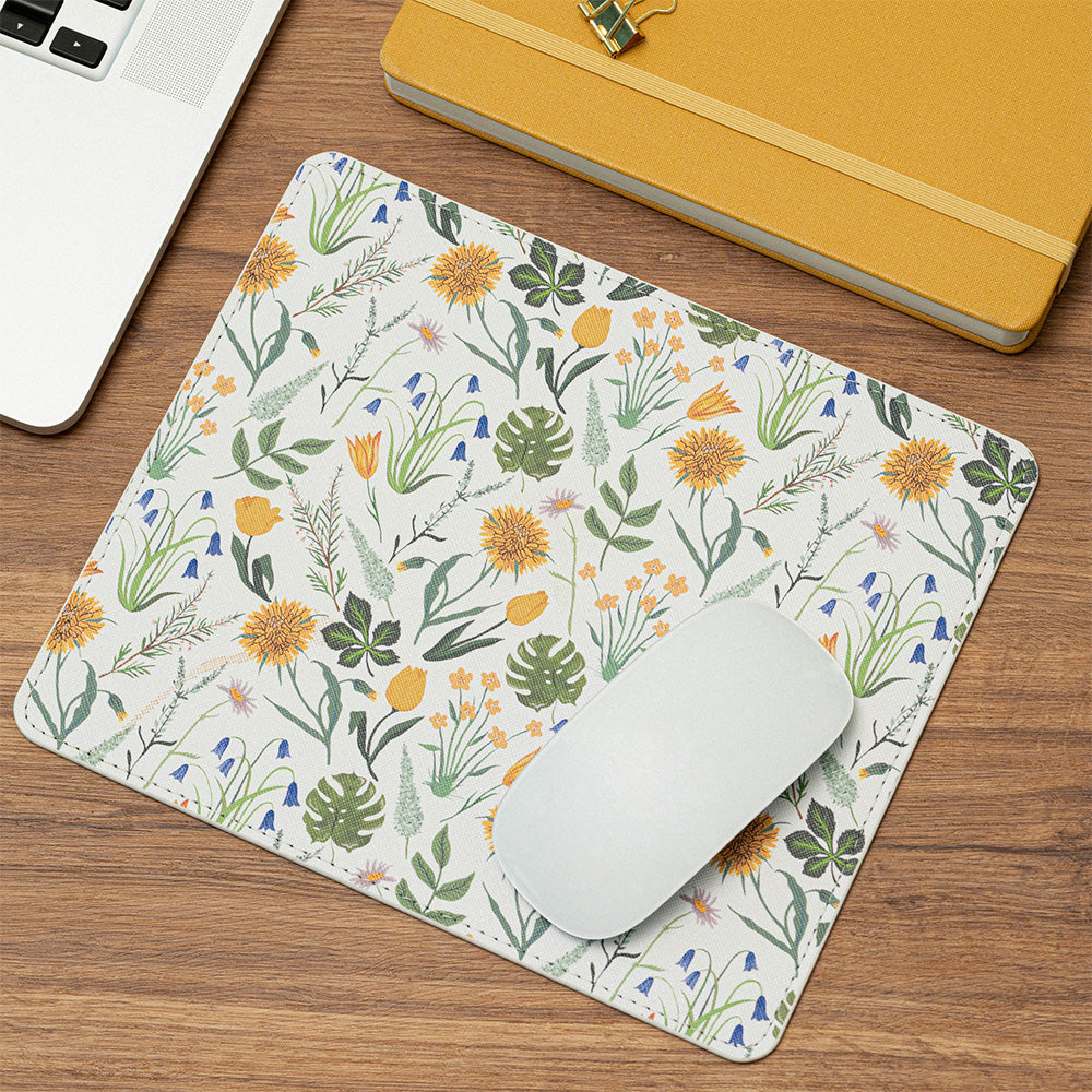 Floral mouse pad with a white mouse on a wooden desk