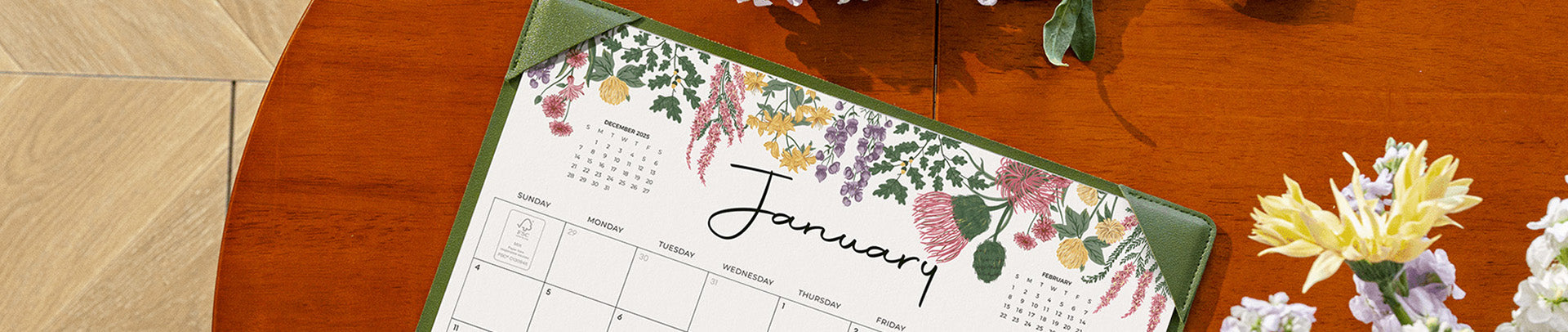 Floral calendar for January on a wooden surface with flowers.