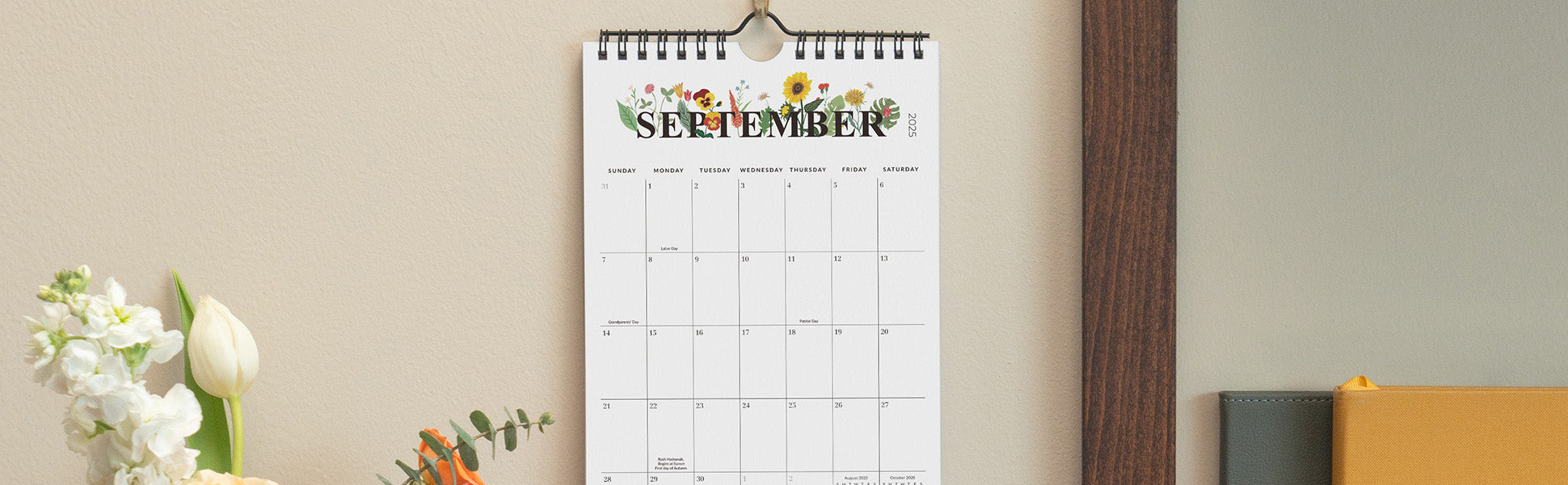Calendar with September on a beige wall, featuring floral decorations.