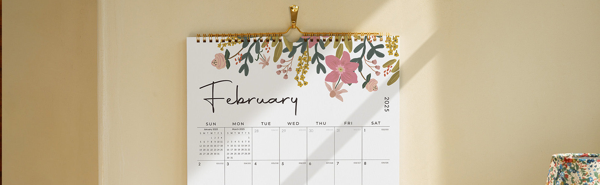 Floral-themed calendar for February on a beige wall