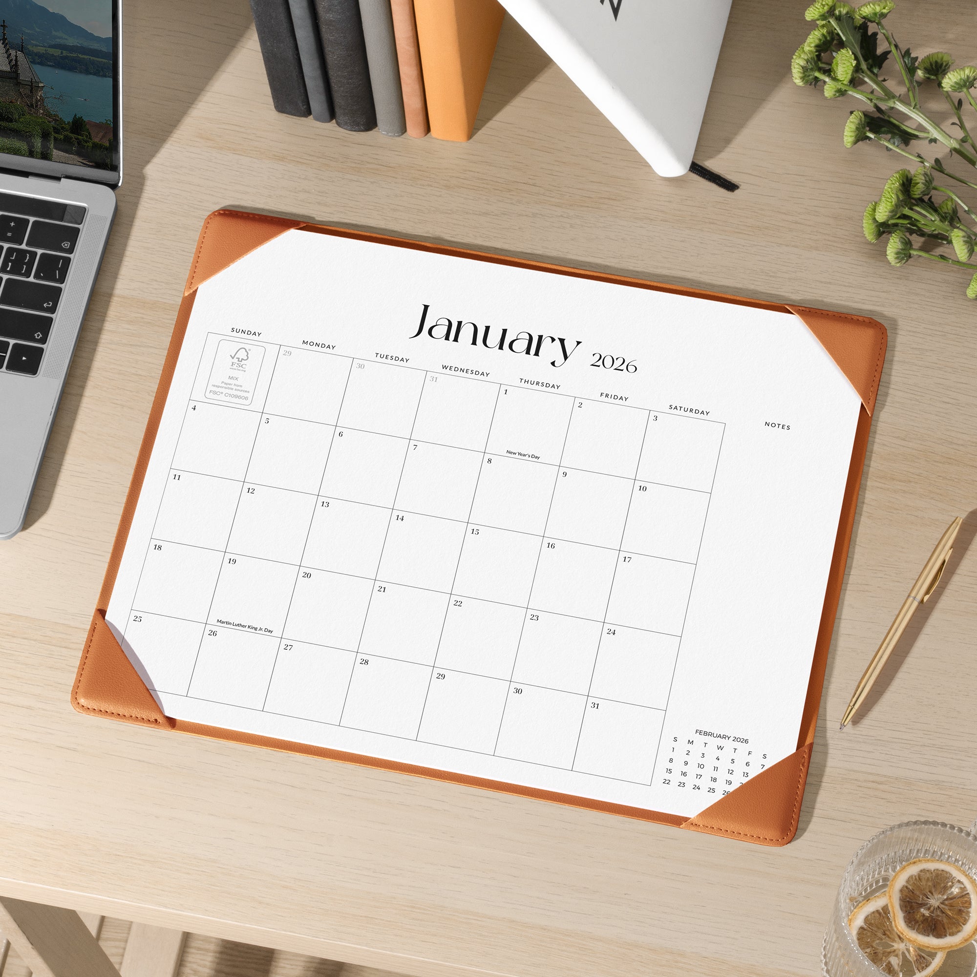 Calendar for January 2026 on a desk with a laptop and pen