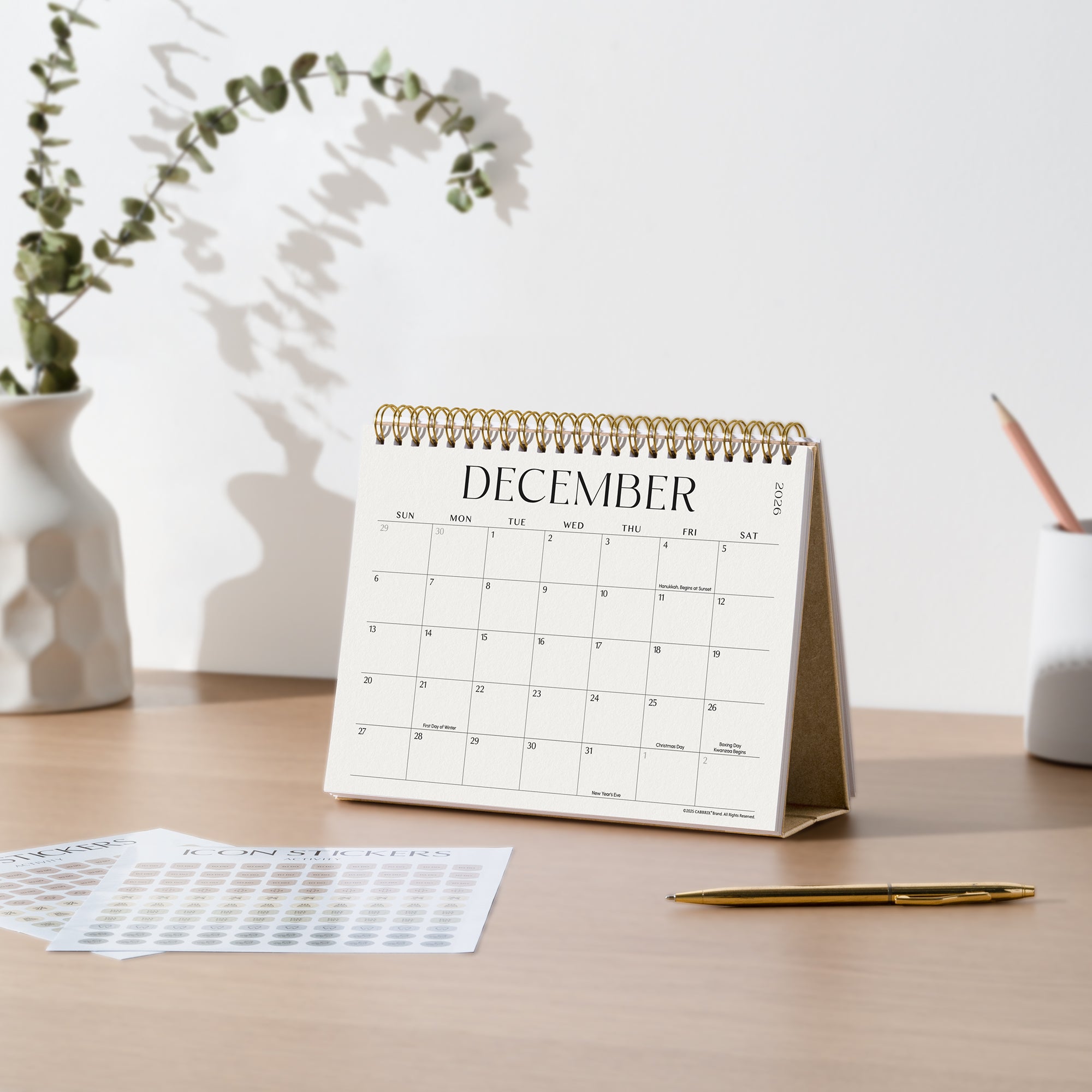 Desk with a December calendar, pen, and decorative elements