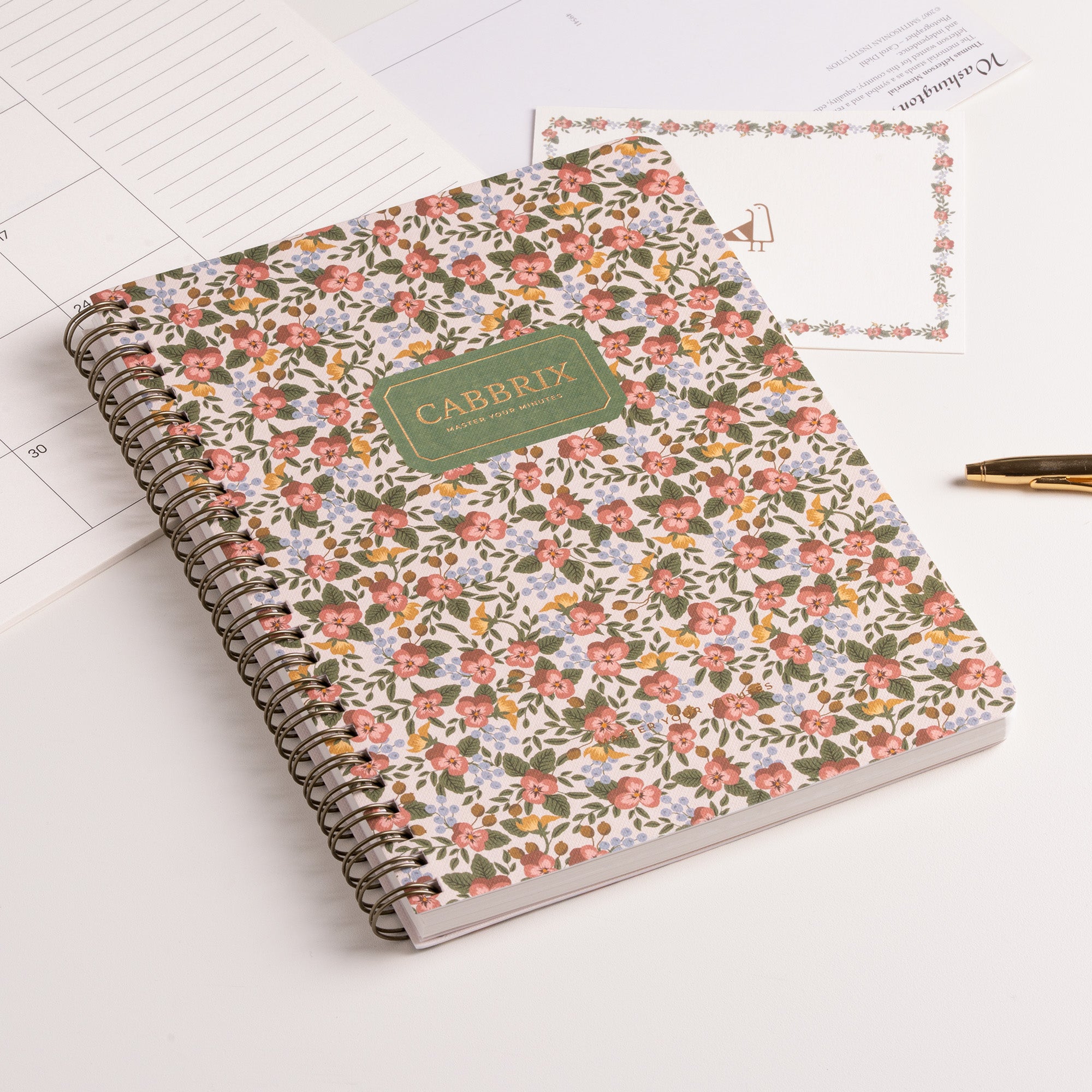 Floral notebook with 'CABRIIX' branding on a white surface