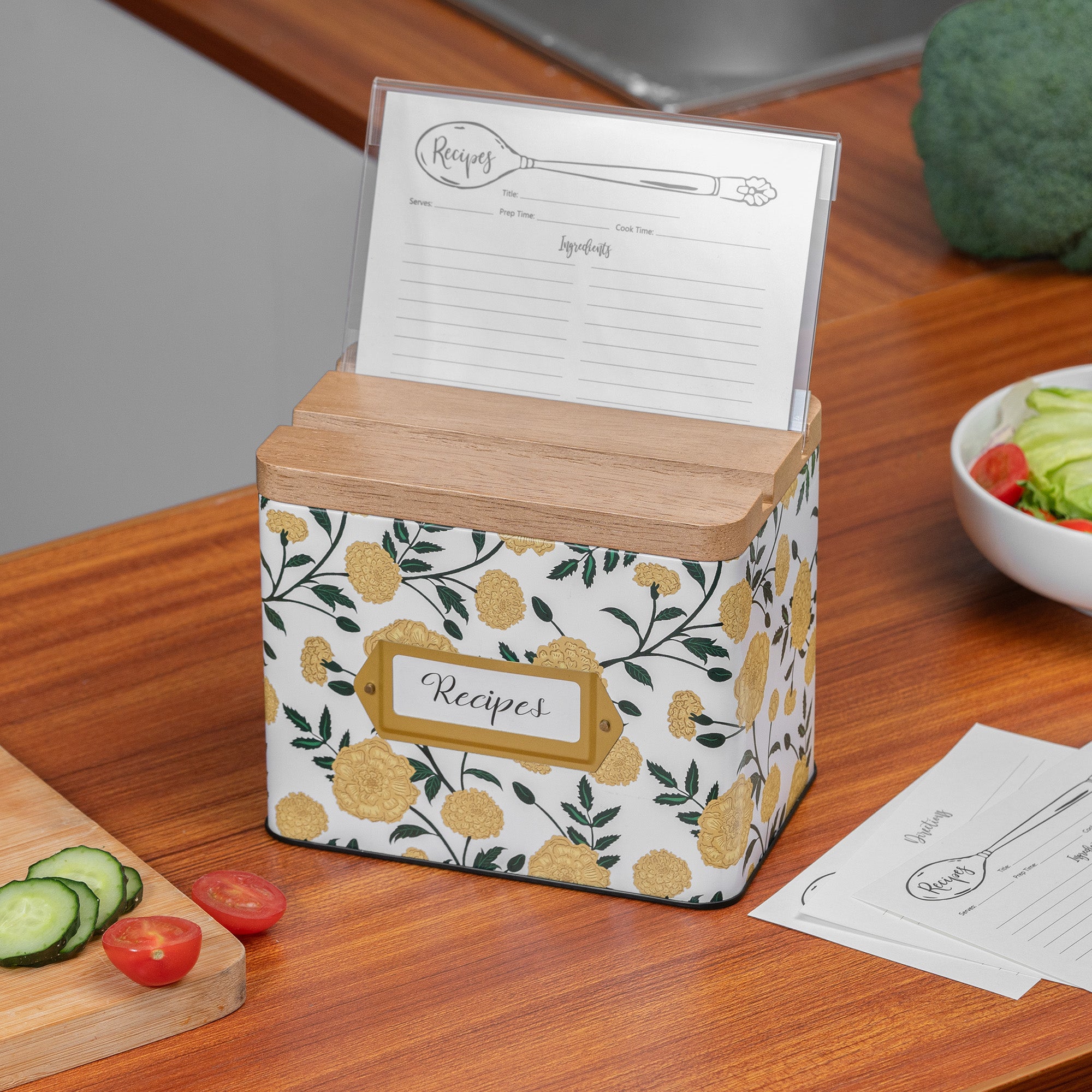 Floral-patterned recipe box with wooden top on a kitchen counter