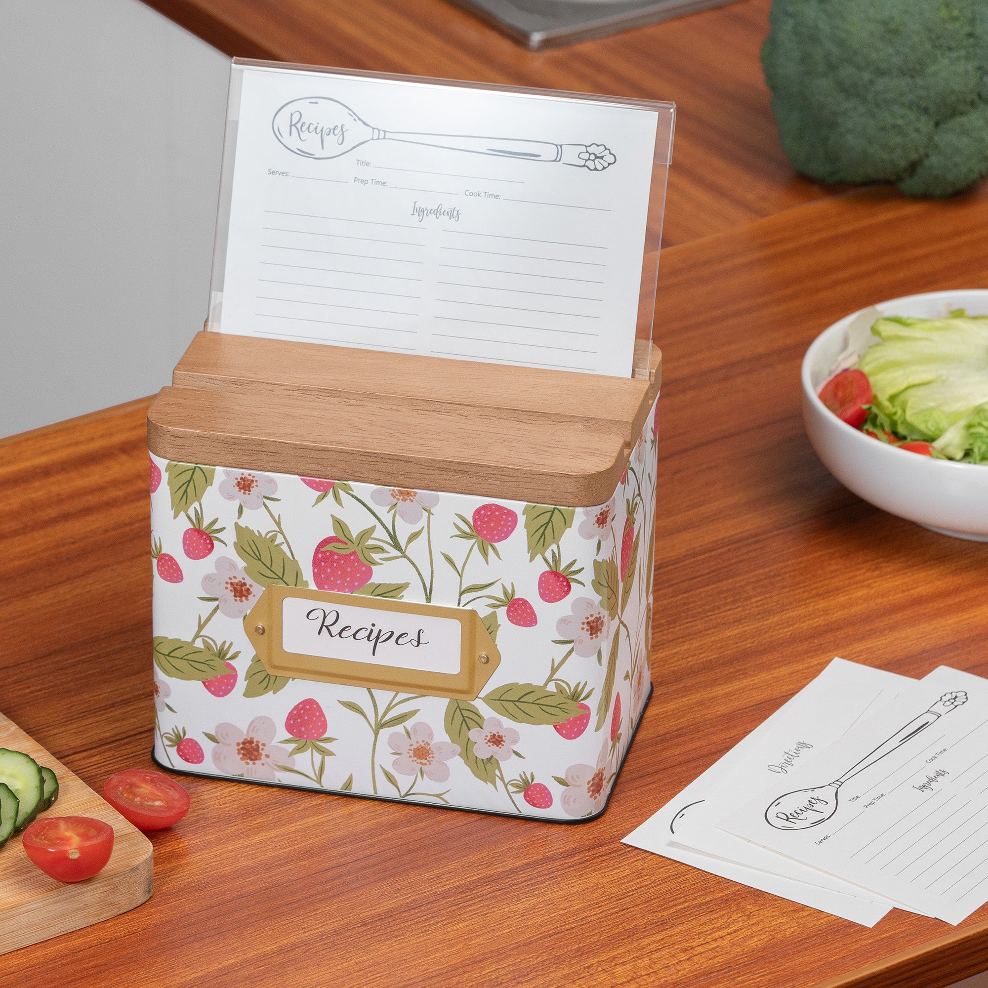 Floral-patterned recipe box with wooden lid on a wooden table