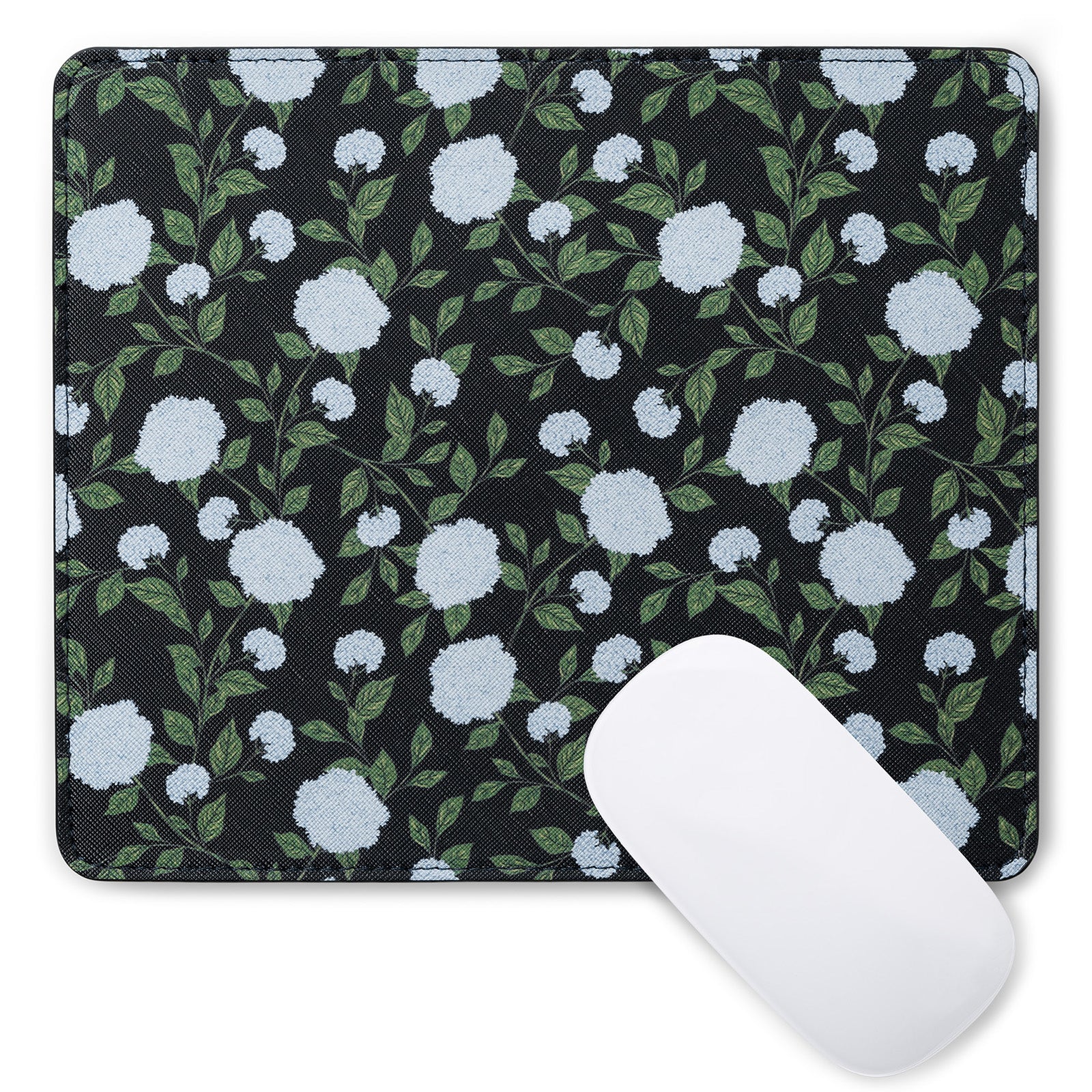 Floral mouse pad with white flowers and green leaves on a black background, accompanied by a white mouse.